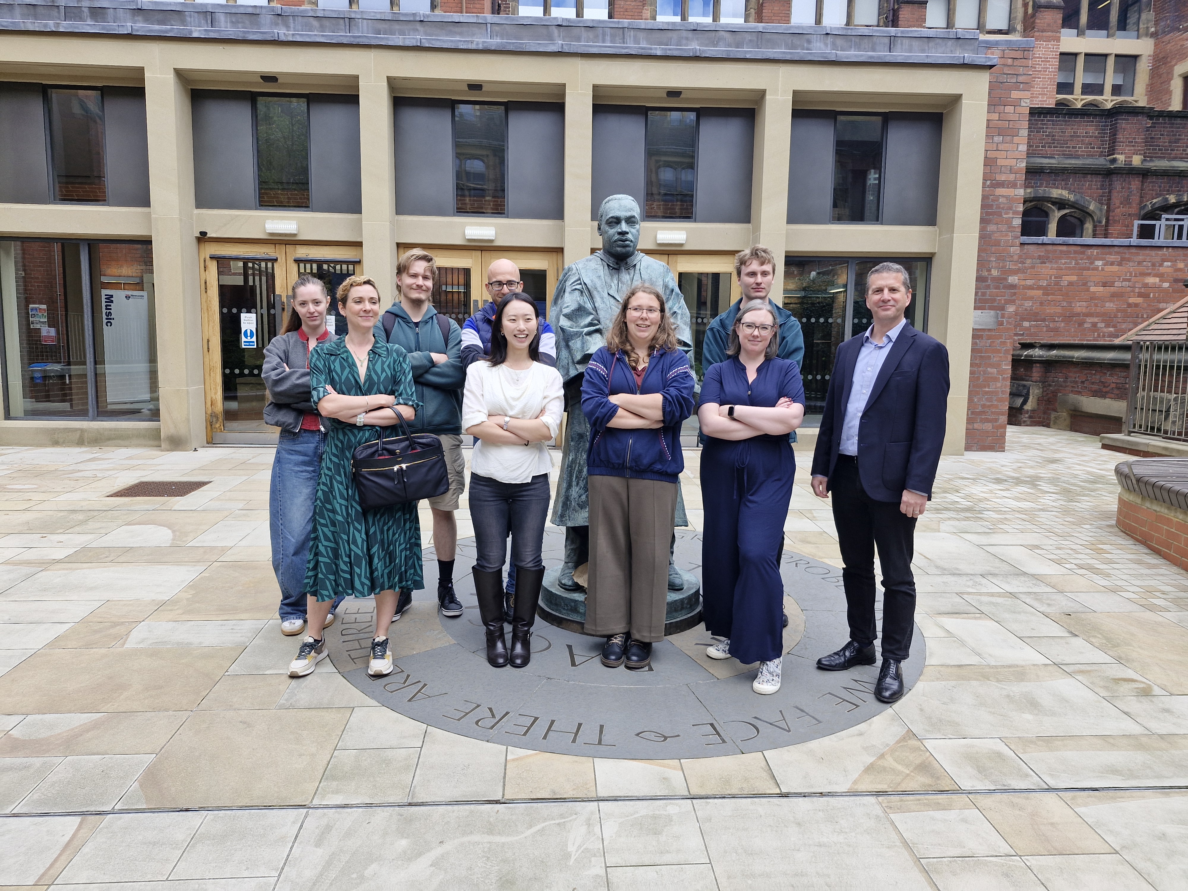 Group photo of MoSMed researchers and a panel of academics and industrialists on Newcastle campus.